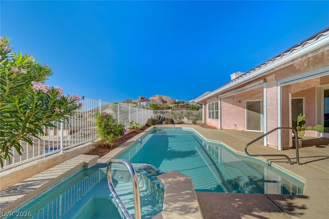 1112 Boletus Drive, Henderson, NV 89011 A sparkling pool and raised spa overlook sweeping desert hillside views under clear blue skies.