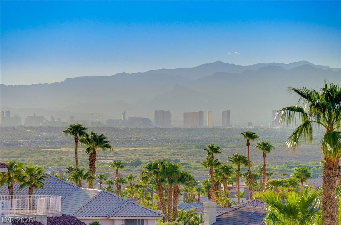 1112 Boletus Drive, Henderson, NV 89011 Dramatic mountain and city skyline vistas unfold above the neighboring tile rooftops and palm trees.