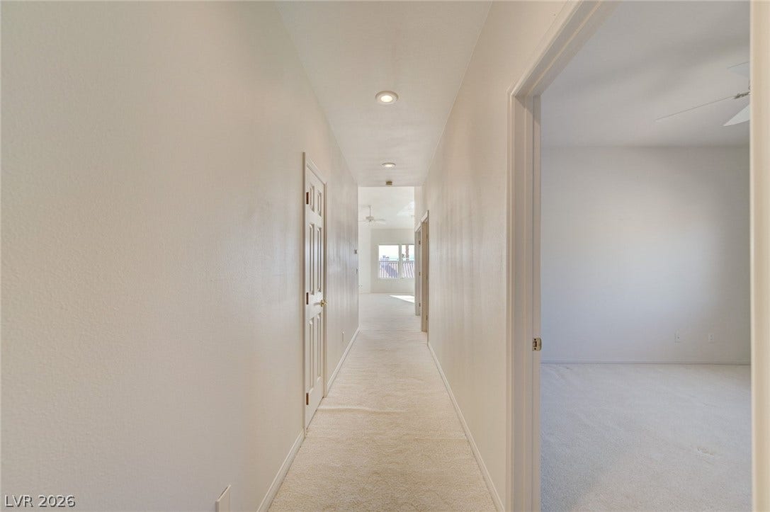 1112 Boletus Drive, Henderson, NV 89011 Recessed lighting guides the way along this neutral hallway featuring soft carpeting underfoot.