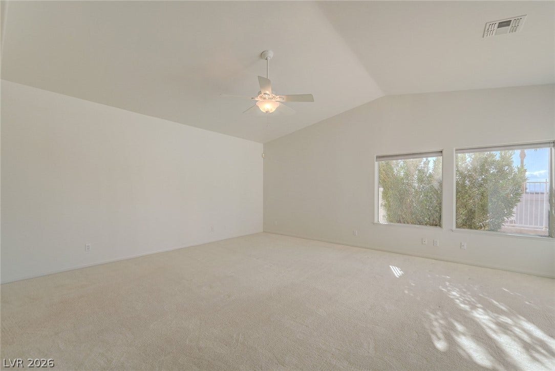 1112 Boletus Drive, Henderson, NV 89011 Vaulted ceilings and plush carpeting define this versatile living space illuminated by large windows.