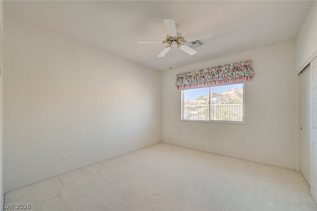 1112 Boletus Drive, Henderson, NV 89011 A window frames desert mountain views from this plushly carpeted room.