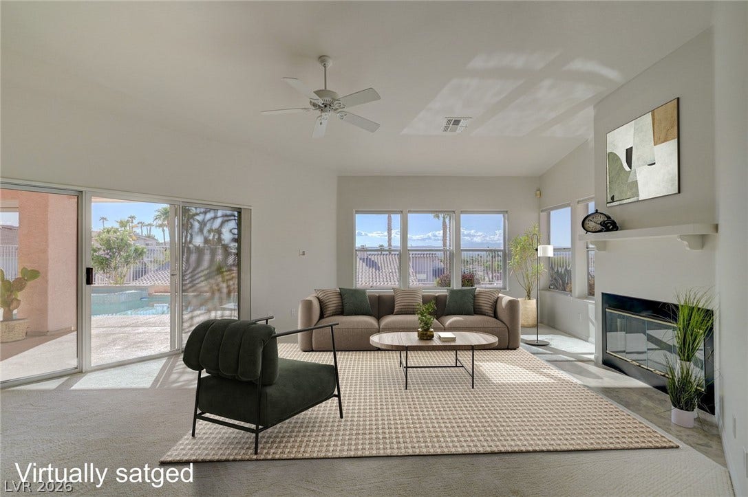 1112 Boletus Drive, Henderson, NV 89011 High ceilings and a cozy fireplace define this airy living space with outdoor access.