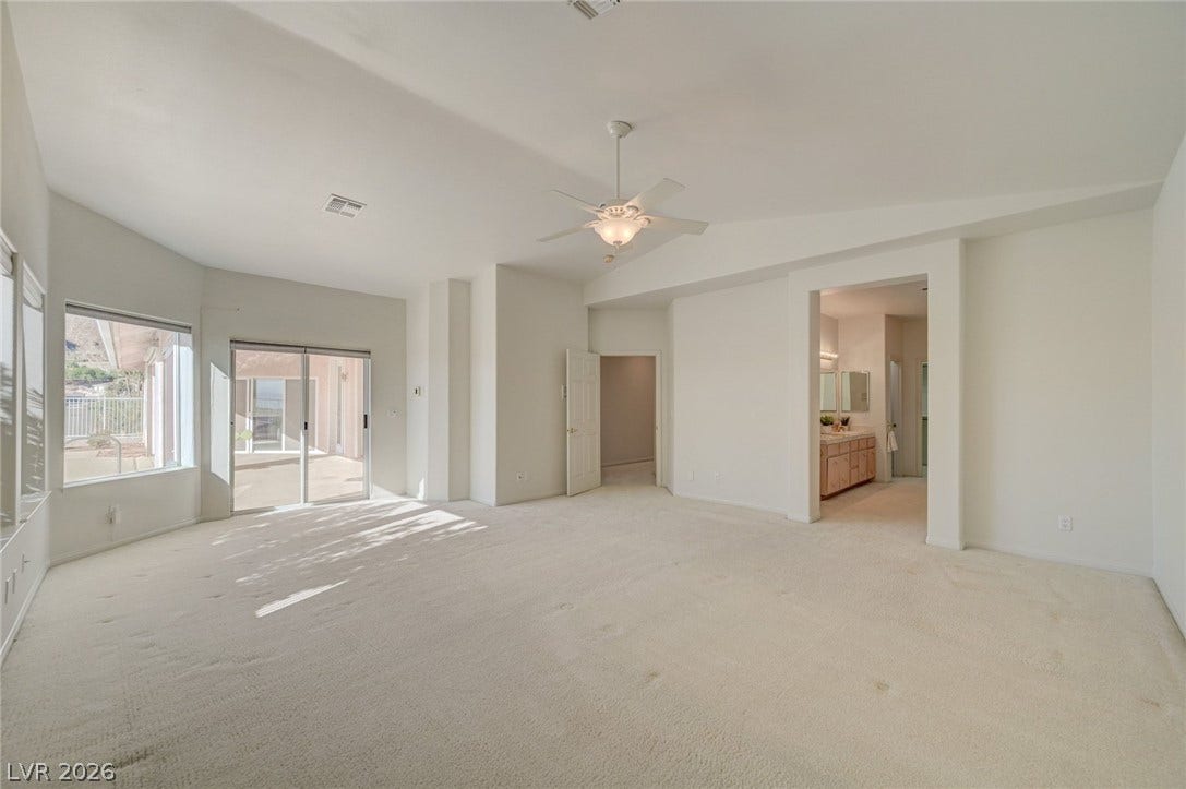 1112 Boletus Drive, Henderson, NV 89011 Vaulted ceilings and broad sliding glass doors define this airy, light-filled primary suite.