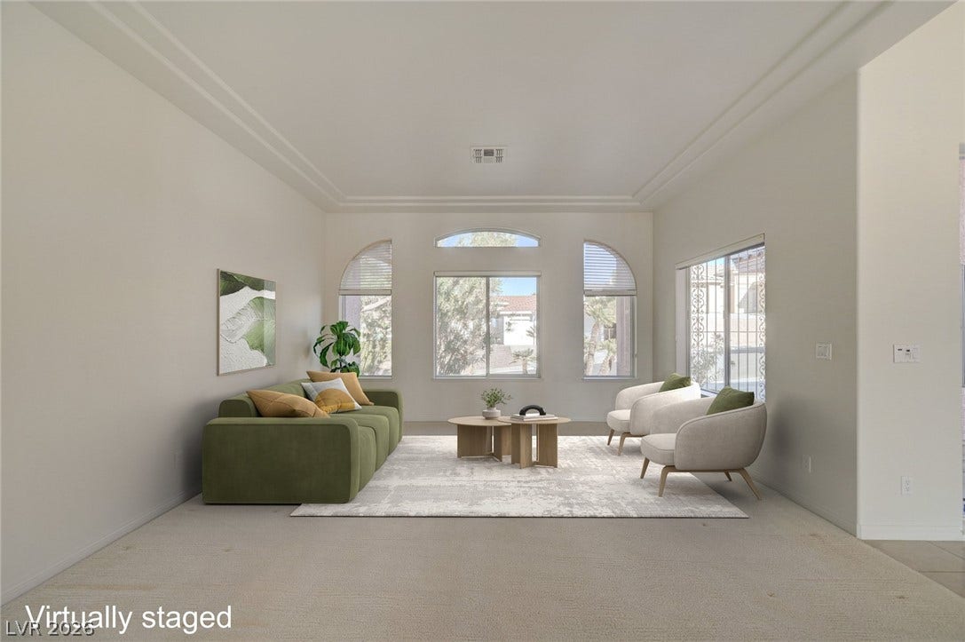 1112 Boletus Drive, Henderson, NV 89011 Arched windows frame tranquil neighborhood views, while classic crown molding traces the high ceiling.