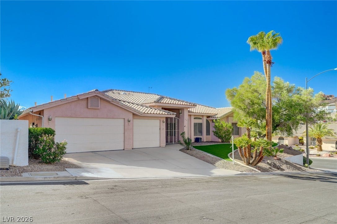 1112 Boletus Drive, Henderson, NV 89011 A spacious driveway and multi-car garage anchor the classic tile-roof exterior of this desert home.