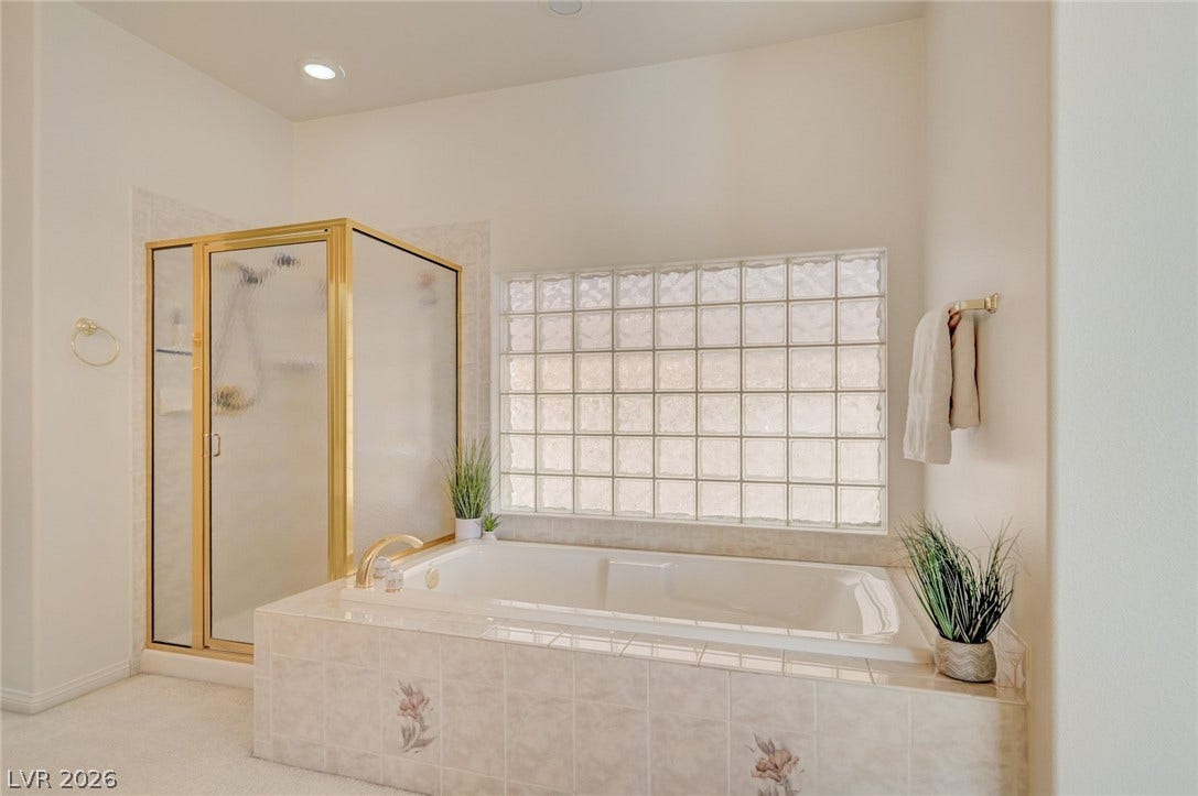 1112 Boletus Drive, Henderson, NV 89011 An inviting soaking tub rests beneath a privacy-enhancing glass block window.