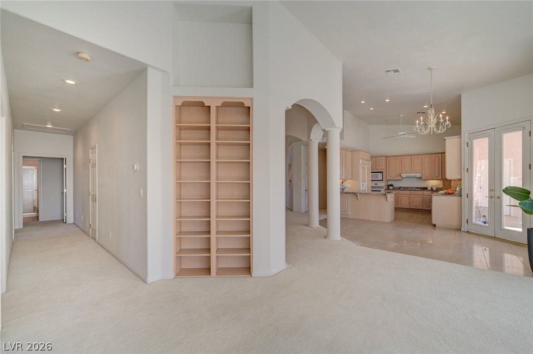 1112 Boletus Drive, Henderson, NV 89011 Built-in shelving and architectural arches lead into the open kitchen and living spaces.