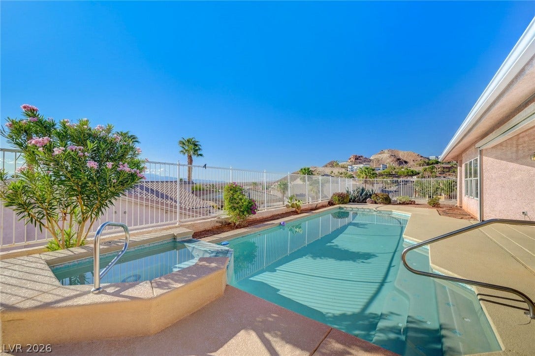 1112 Boletus Drive, Henderson, NV 89011 An inviting backyard swimming pool and integrated spa overlook distant mountain vistas.