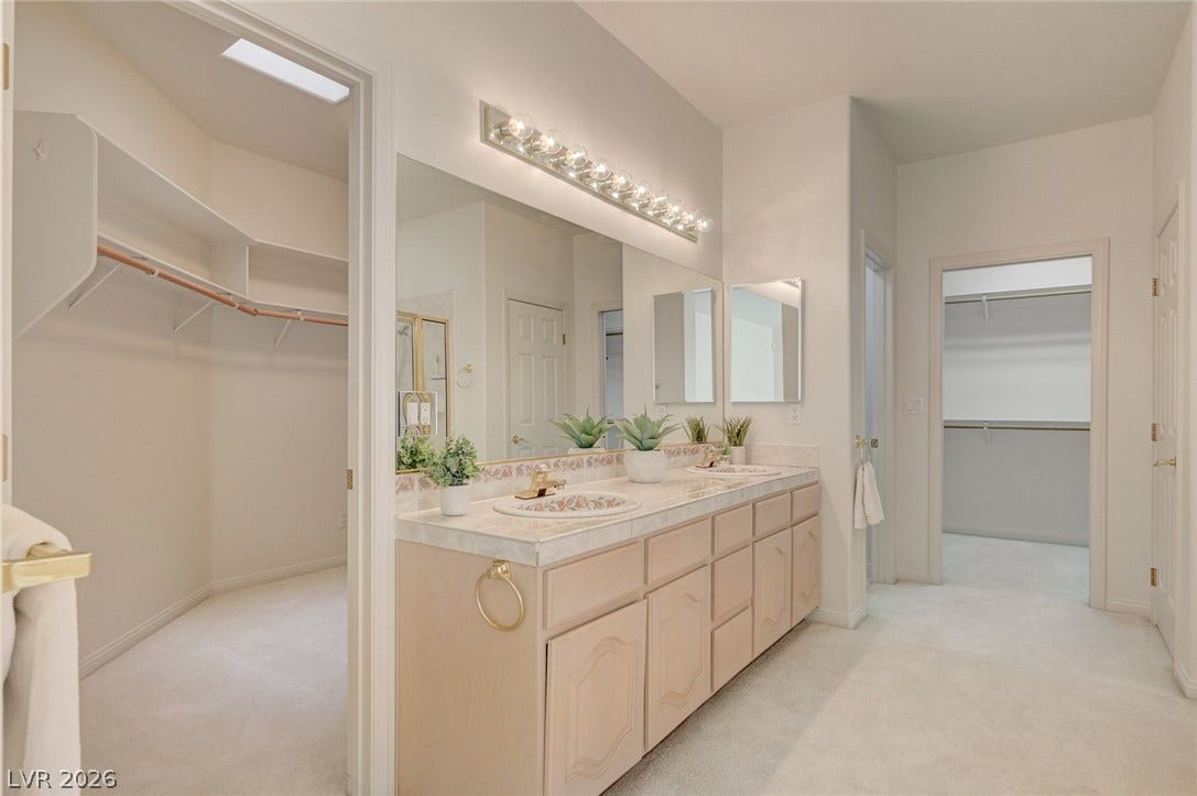 1112 Boletus Drive, Henderson, NV 89011 An expansive vanity area connects directly to multiple walk-in closets and private bath spaces.