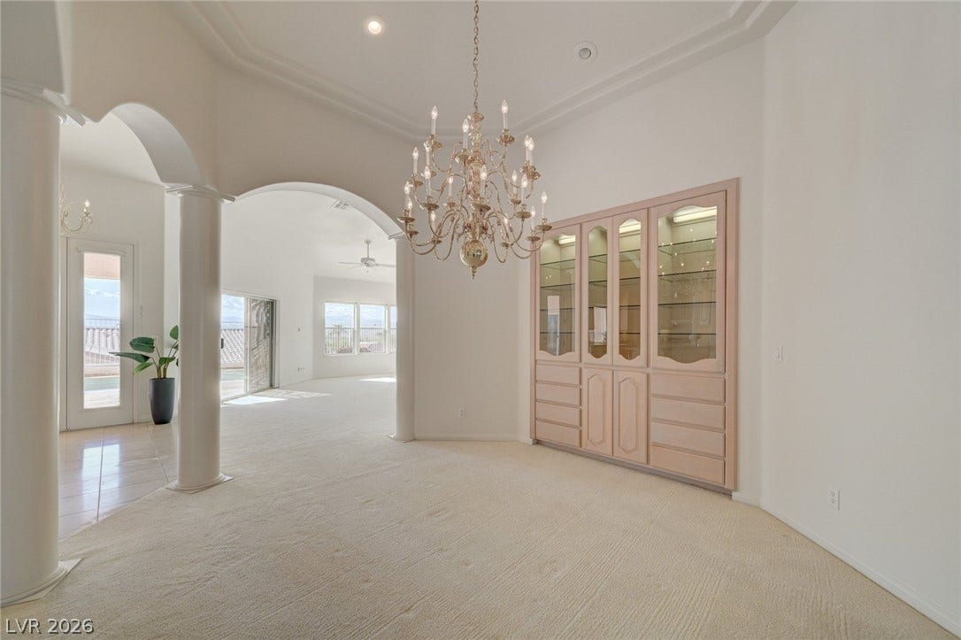 1112 Boletus Drive, Henderson, NV 89011 Elegant arches and a classic chandelier define this spacious dining area with built-in cabinetry.