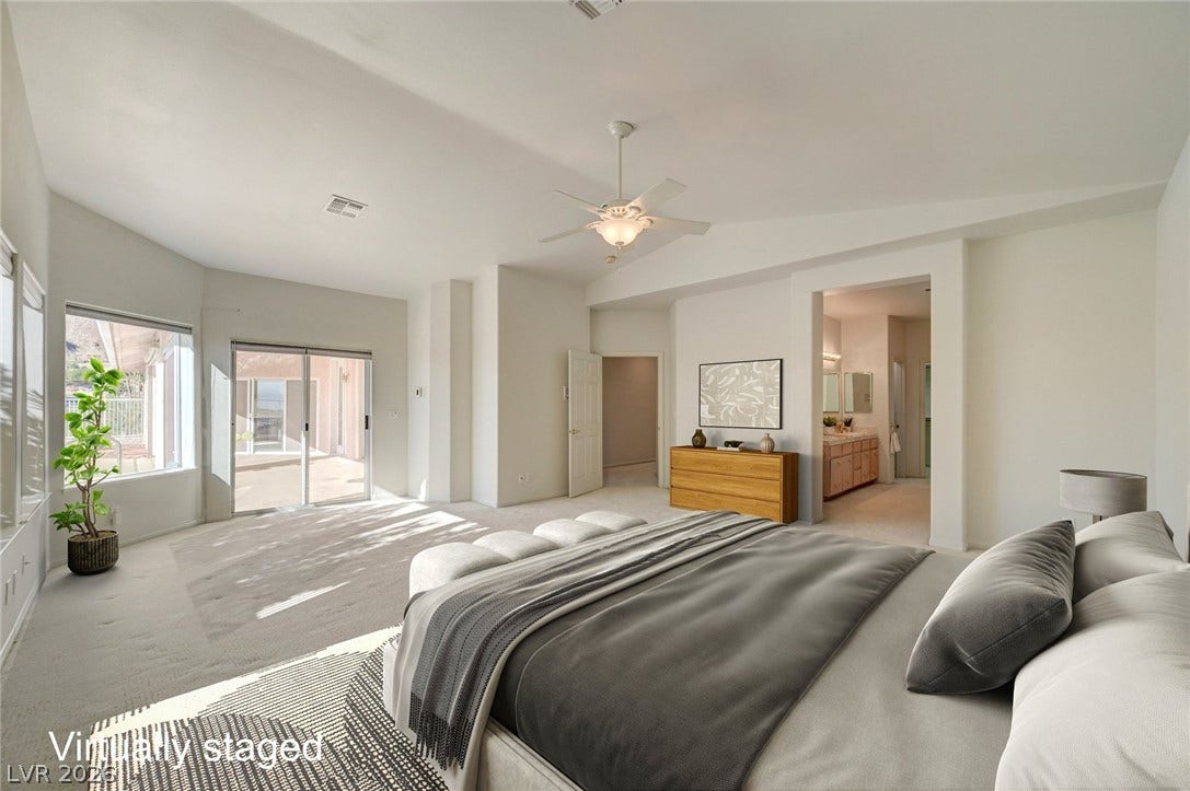 1112 Boletus Drive, Henderson, NV 89011 A spacious bedroom offers vaulted ceilings and sliding glass door access to the outdoors.