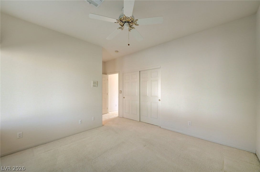 1112 Boletus Drive, Henderson, NV 89011 Plush carpeting anchors this bright bedroom complete with sliding closet doors.