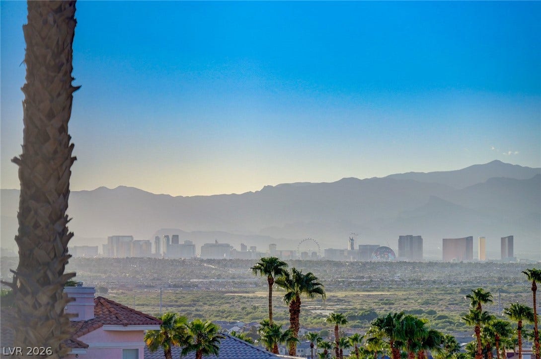 1112 Boletus Drive, Henderson, NV 89011 Distant mountains frame a wide perspective of the city skyline rising beyond natural desert landscape.