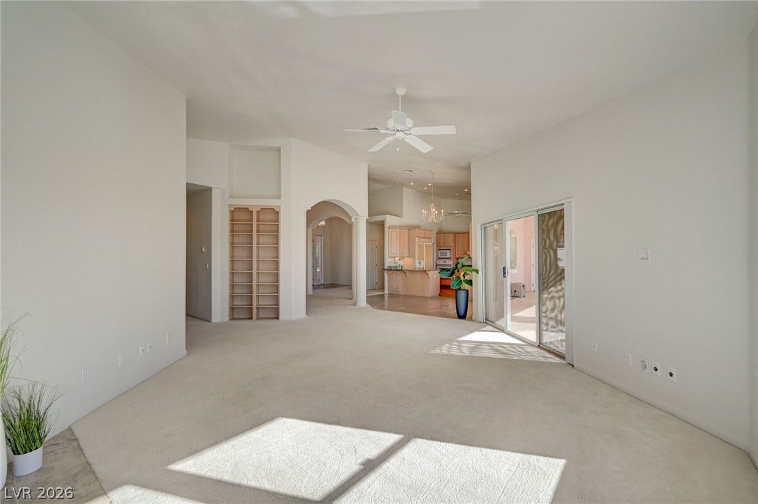 1112 Boletus Drive, Henderson, NV 89011 An open floorplan connects the carpeted living space to the kitchen through arched entryways.