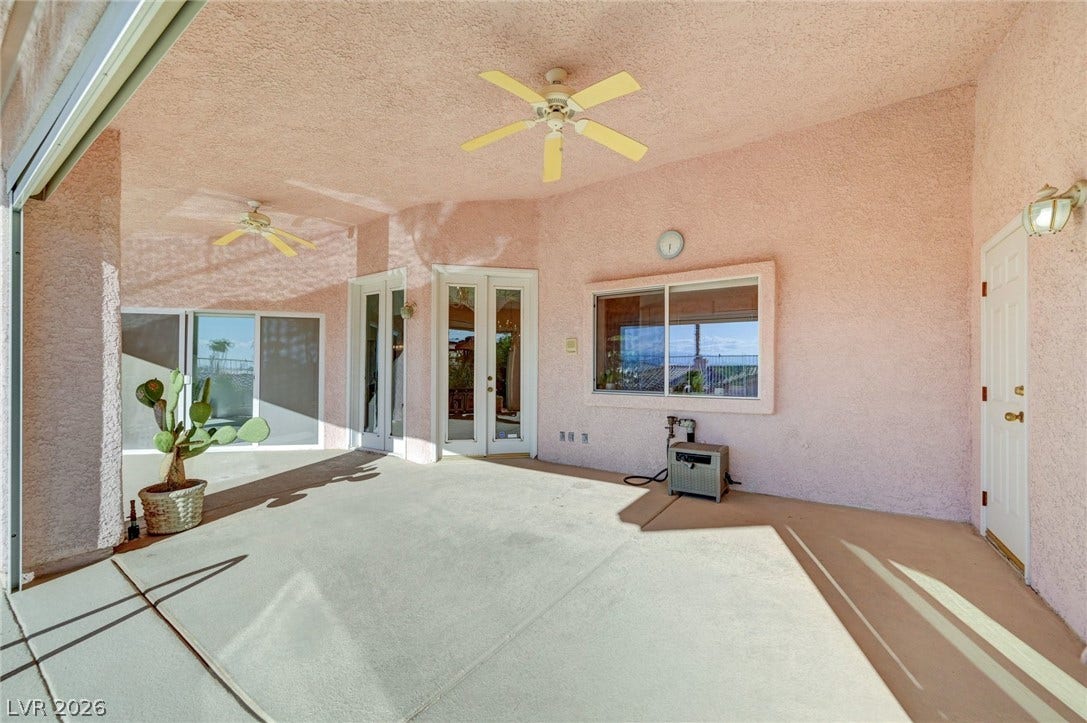 1112 Boletus Drive, Henderson, NV 89011 Shaded concrete patio features textured stucco walls and direct indoor-outdoor transition through French doors.