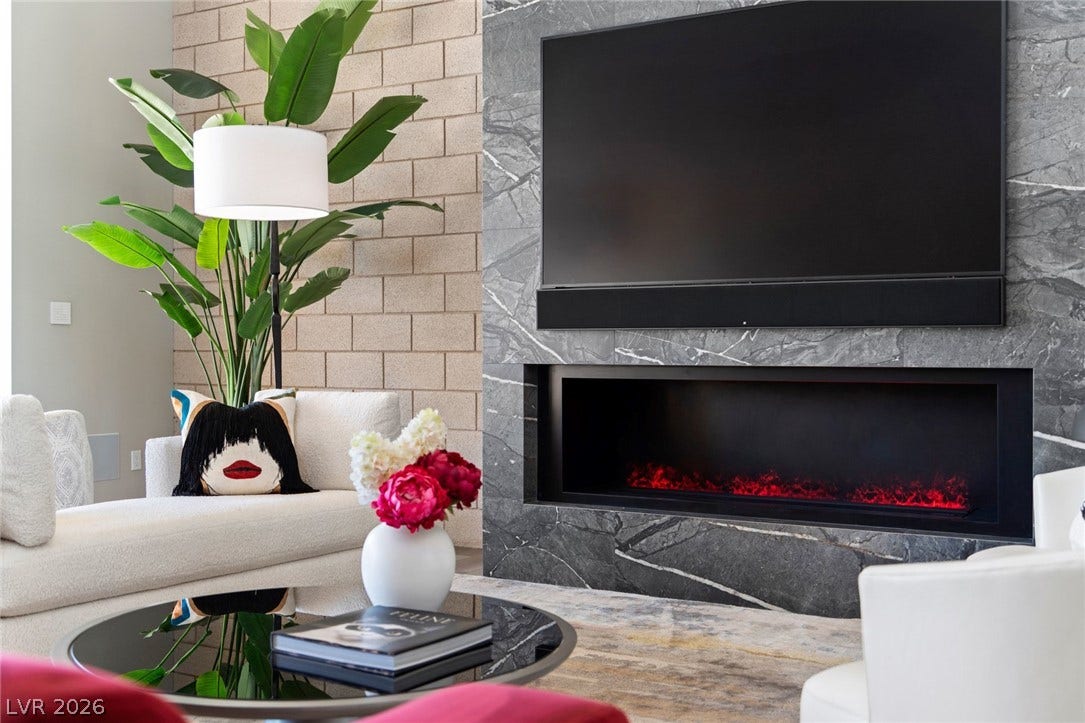 37 Reflection Shores Lane, Henderson, NV 89011 A modern fireplace is set into a sleek stone accent wall.