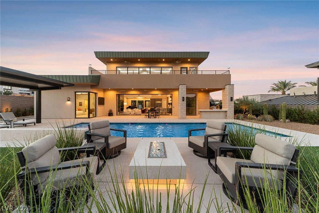 37 Reflection Shores Lane, Henderson, NV 89011 An inviting backyard oasis features a modern pool, fire pit, and multi-level architectural design.