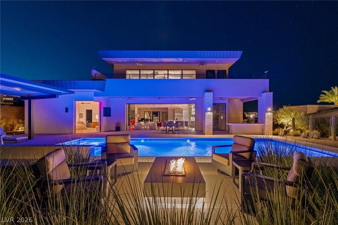 37 Reflection Shores Lane, Henderson, NV 89011 A sparkling geometric pool and modern fire pit anchor this dramatic multi-level desert retreat.
