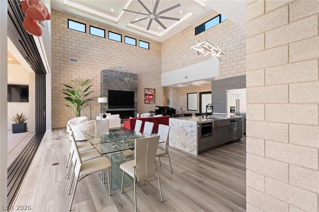 37 Reflection Shores Lane, Henderson, NV 89011 Soaring ceilings and concrete block walls frame this expansive open-concept living and dining area.