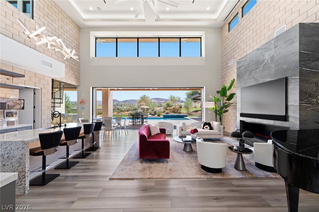 37 Reflection Shores Lane, Henderson, NV 89011 Towering ceilings and pocketing glass walls frame scenic mountain and pool vistas.