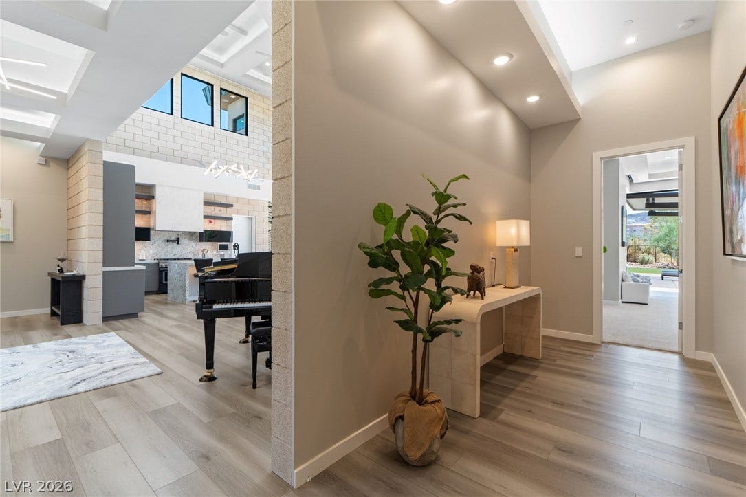 37 Reflection Shores Lane, Henderson, NV 89011 Smooth wood-look flooring guides visitors through this welcoming entryway with tall ceilings.