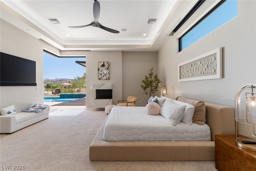 37 Reflection Shores Lane, Henderson, NV 89011 High recessed tray ceilings frame a bedroom opening directly to the private pool area.