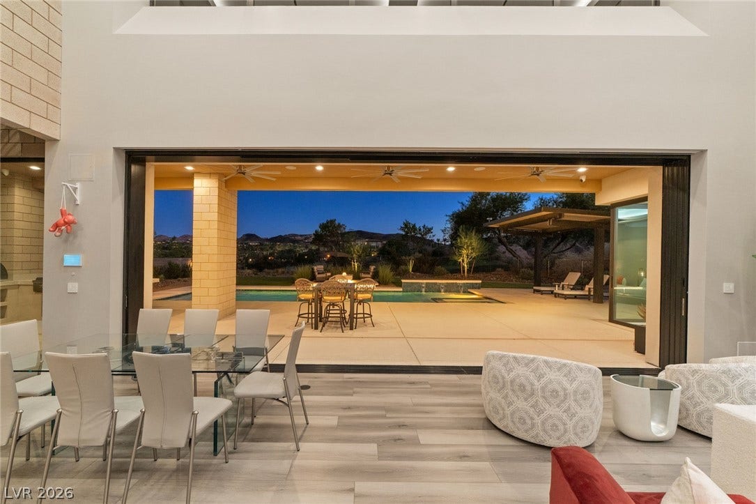 37 Reflection Shores Lane, Henderson, NV 89011 Retractable glass doors merge the indoor living space with a poolside patio and mountain views.