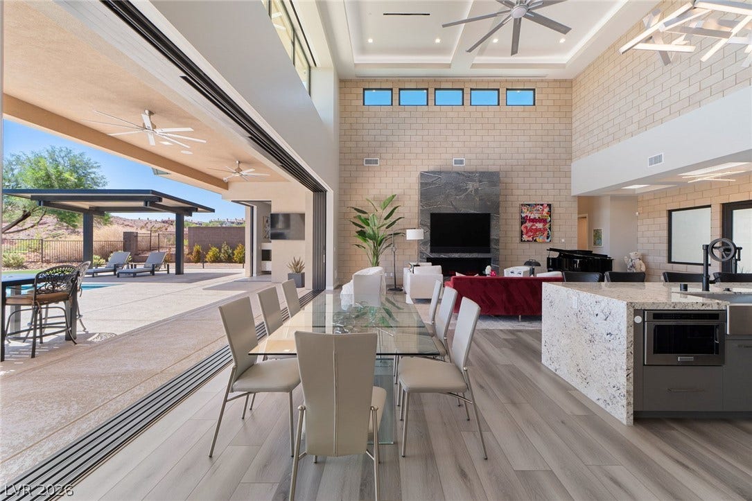 37 Reflection Shores Lane, Henderson, NV 89011 Massive pocket doors seamlessly connect the open-concept living and dining areas to the outdoors.