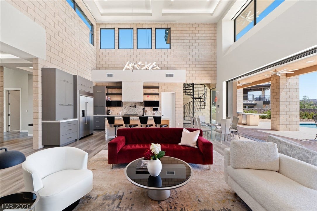37 Reflection Shores Lane, Henderson, NV 89011 Double-height ceilings and massive sliding doors frame this modern, light-filled open great room.