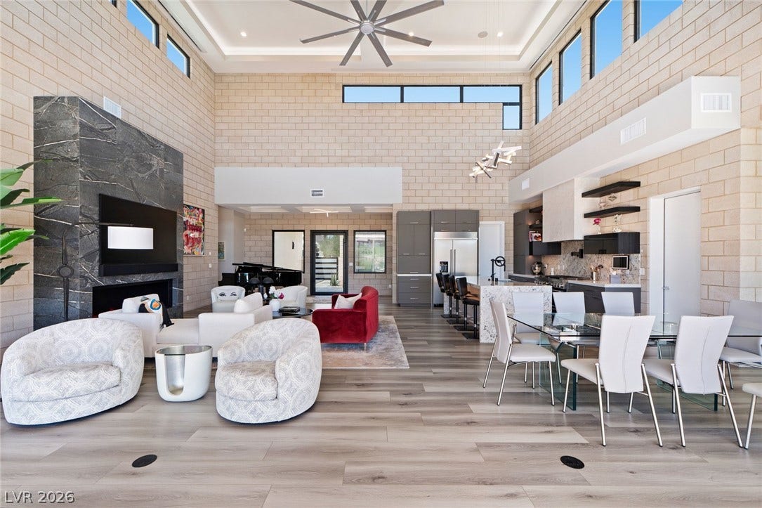37 Reflection Shores Lane, Henderson, NV 89011 Towering ceilings and exposed block walls define this dramatic open-concept living space.