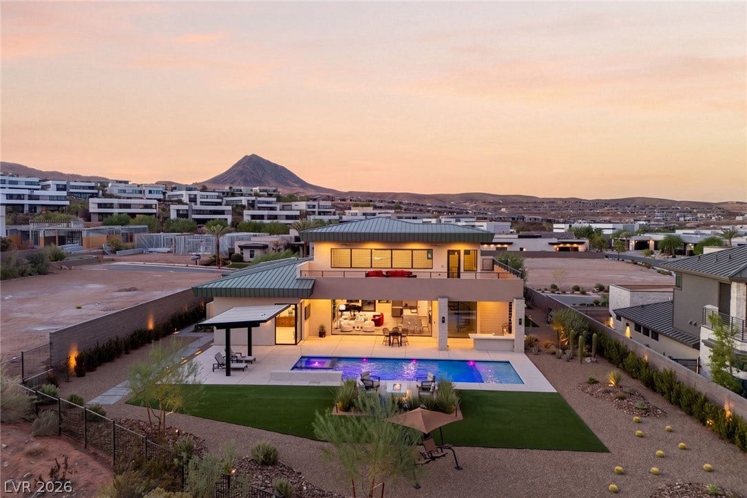 37 Reflection Shores Lane, Henderson, NV 89011 An inviting backyard oasis features a modern pool against a dramatic mountain backdrop.