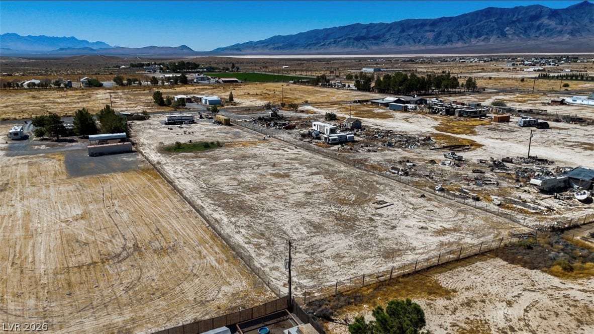 3160 Wall Street, Pahrump, NV 89061 A spacious desert lot bordered by fencing offers sweeping views of the surrounding mountains.