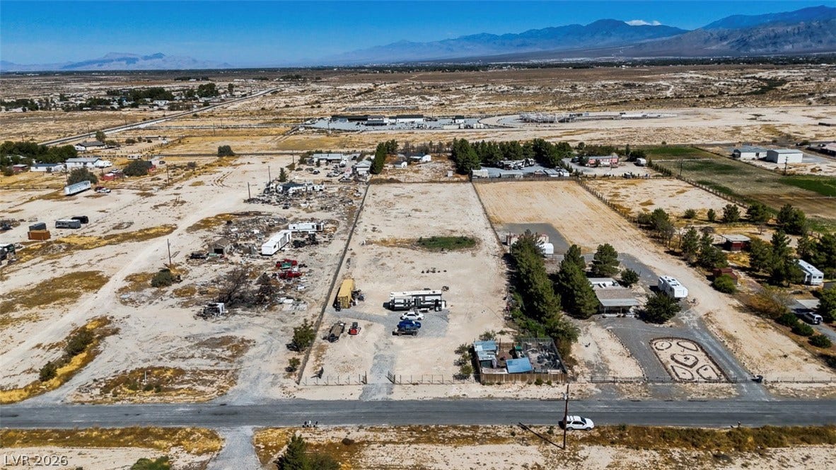 3160 Wall Street, Pahrump, NV 89061 Vast desert views frame this expansive parcel of land under clear blue skies.