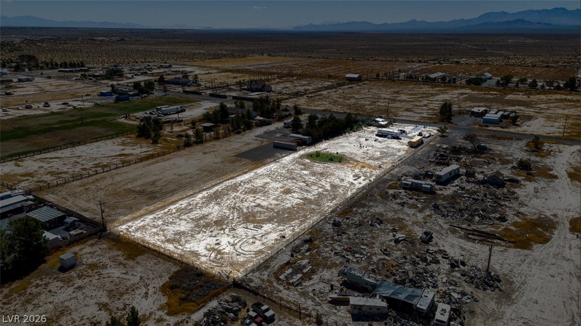 3160 Wall Street, Pahrump, NV 89061 An aerial perspective showcases a spacious desert lot set against a majestic mountain backdrop.