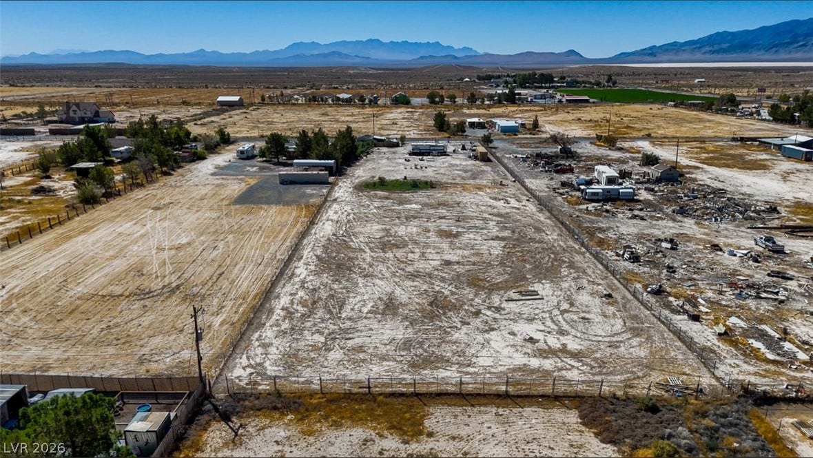 3160 Wall Street, Pahrump, NV 89061 A spacious level lot is surrounded by fencing and framed by distant mountain peaks.