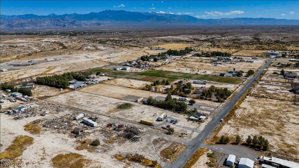 3160 Wall Street, Pahrump, NV 89061 A sweeping aerial view showcases desert landscape and distant mountain ranges under clear blue skies.