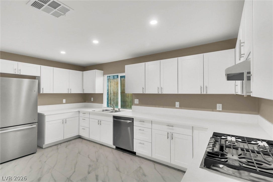 Sleek modern cabinetry and stone counters define this fully updated kitchen space.