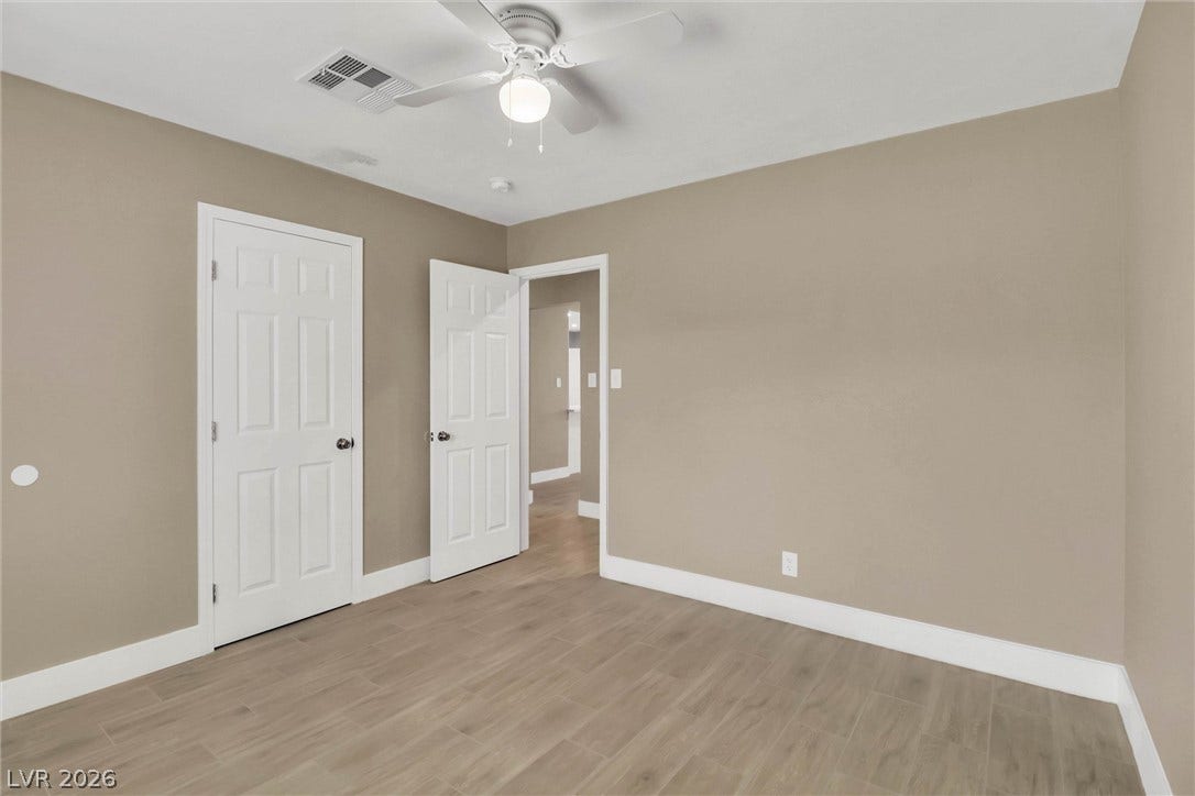 Smooth wood-look flooring and crisp white trim accent this versatile space.