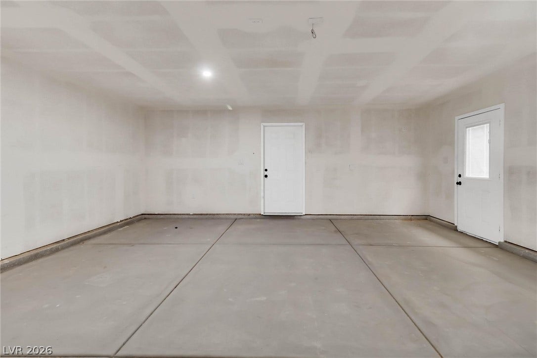 Smooth concrete floors and unfinished drywall await personalization in this spacious garage.