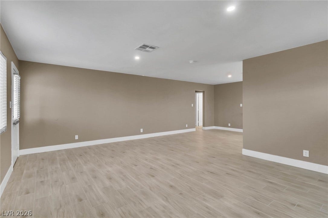 Smooth wood-look tile flooring and crisp white trim accent this versatile living area.