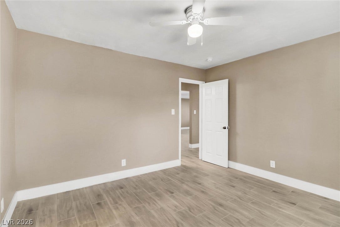 Gleaming tile flooring and crisp white trim accent this versatile empty space.