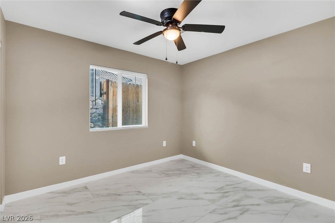Polished tile flooring and clean lines define this versatile secondary bedroom space.