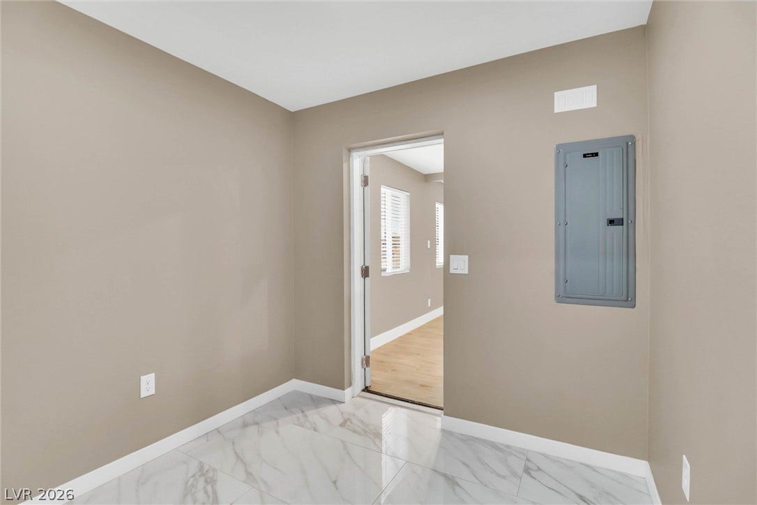 Polished tile flooring and neutral walls define this versatile storage or utility space.