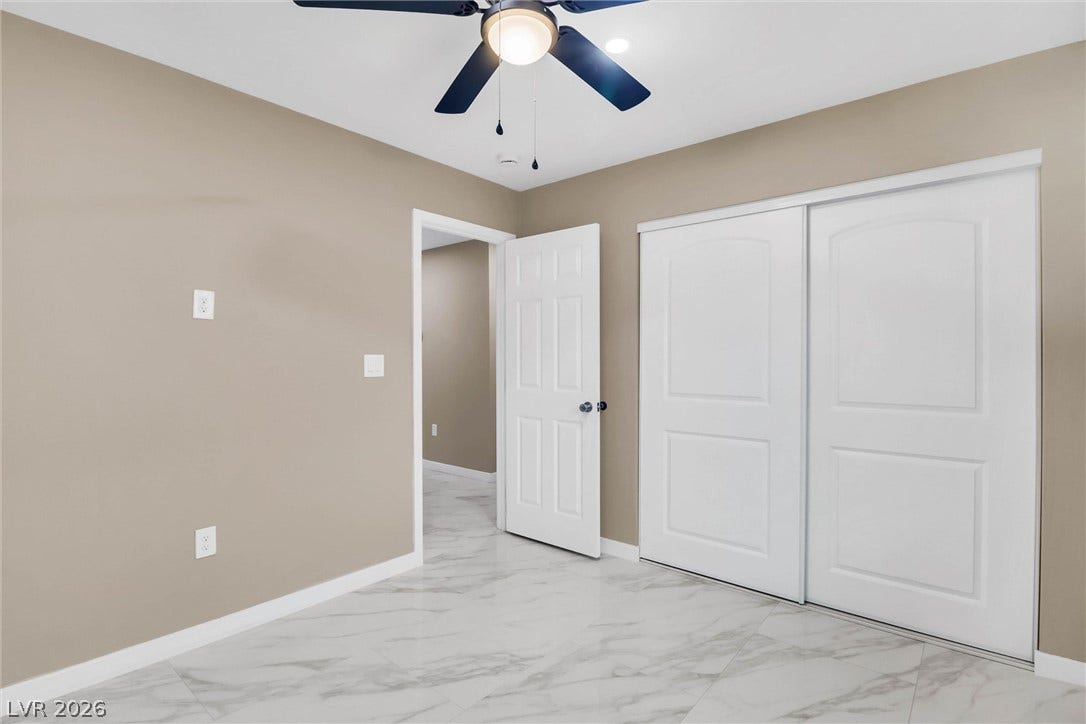 Gleaming marble-patterned tile floors and clean white trim define this versatile room.