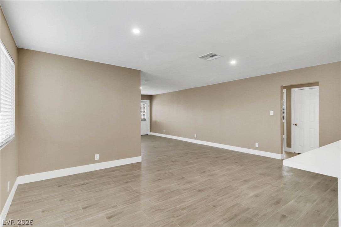 An open floorplan with recessed lighting over durable wood-look tile flooring.