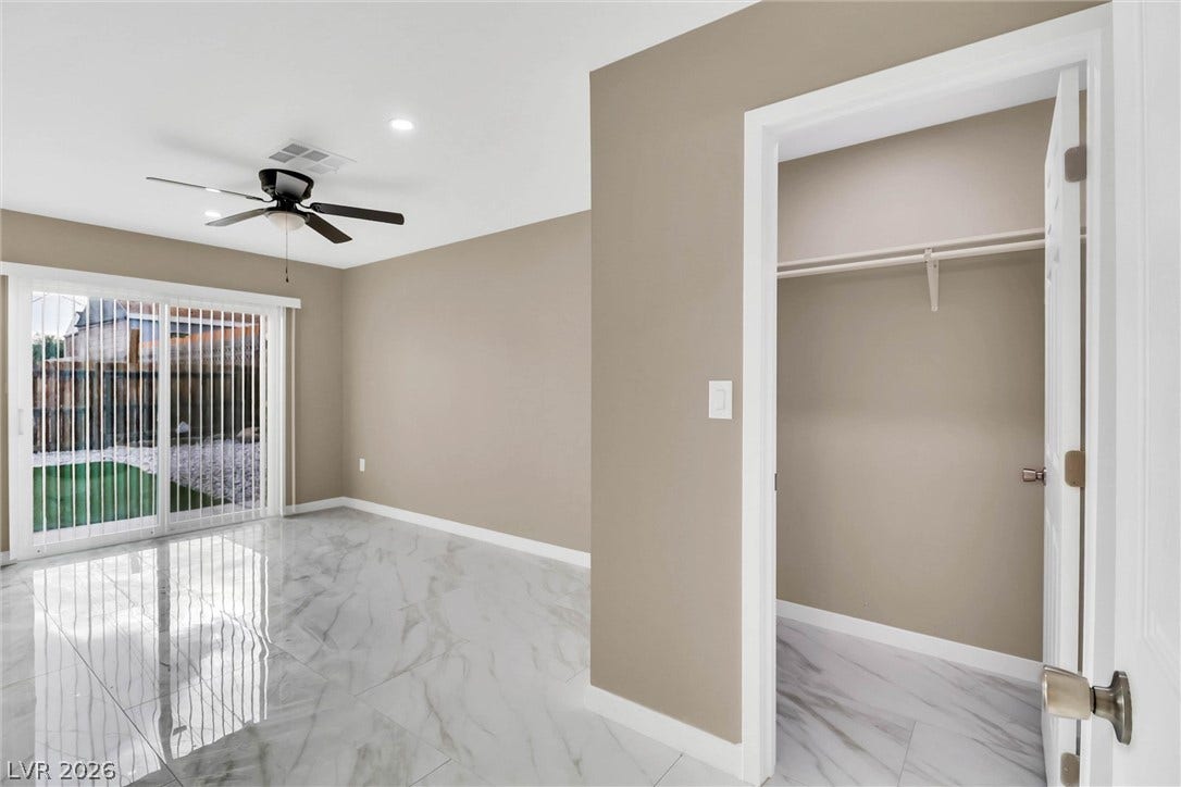 Polished tile flooring and sliding doors leading outside highlight this versatile room.