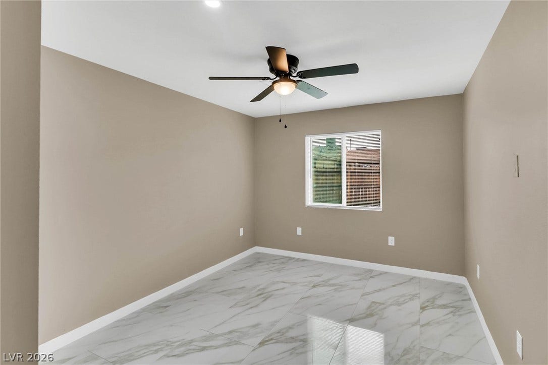 Polished tile flooring and clean lines define this versatile secondary bedroom space.