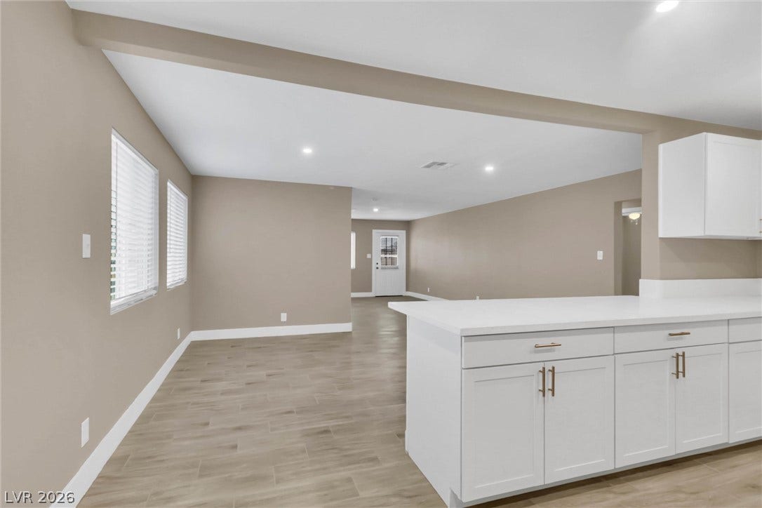 An open floor plan connects the kitchen counters to the adjacent living spaces.