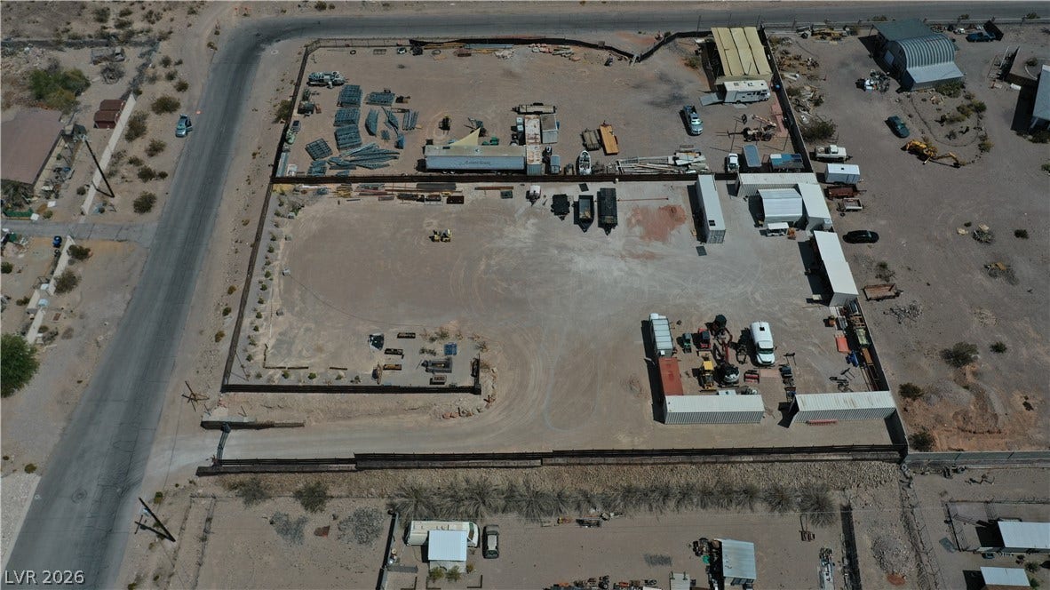1111 E Warm Springs Road, Henderson, NV 89015 An aerial perspective showcases a fully enclosed industrial lot with gated access.