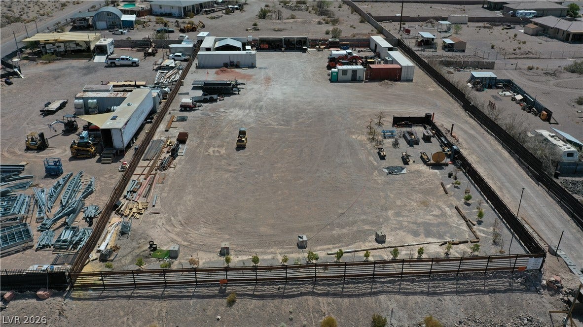 1111 E Warm Springs Road, Henderson, NV 89015 A spacious and secured industrial yard features expansive dirt surfaces ideal for storage and operations.